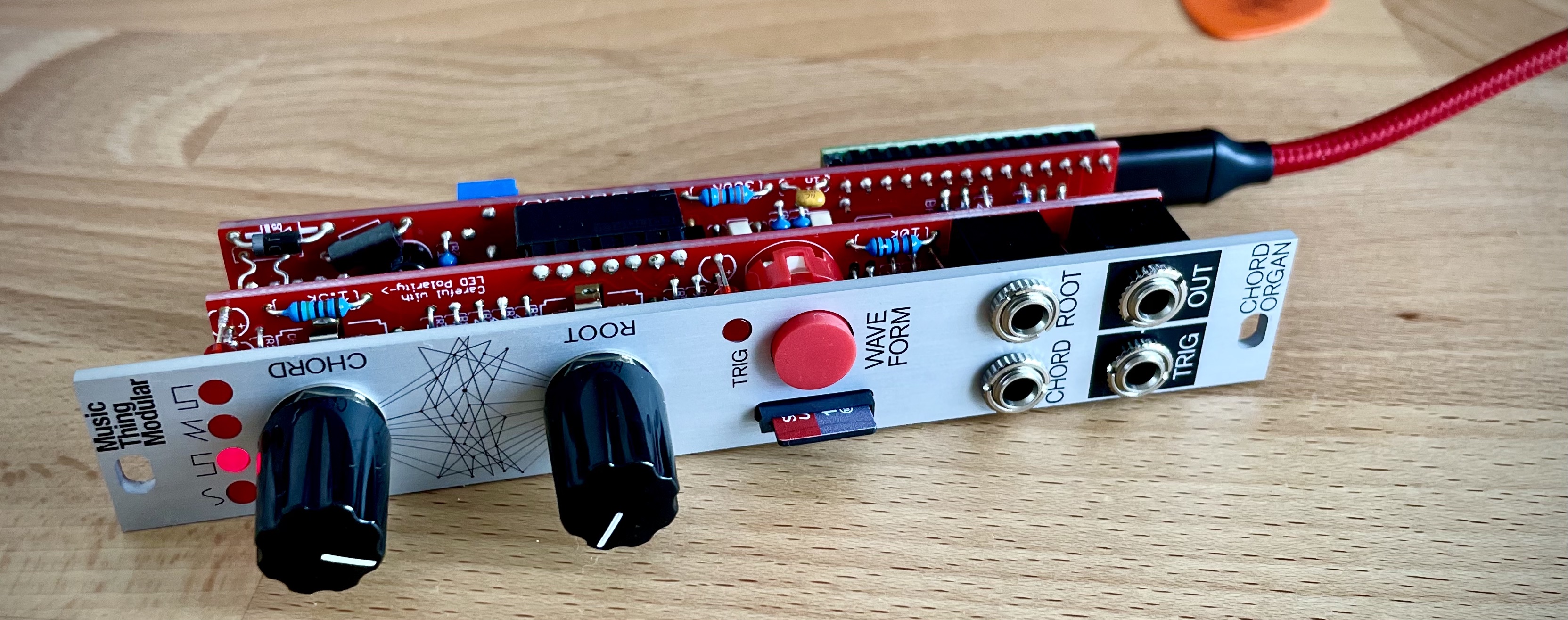 Chord Organ module on a desk, cable atached.